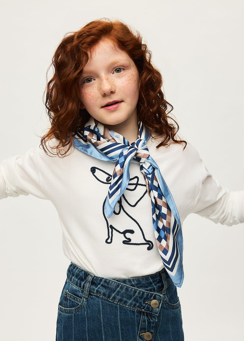 Girl wearing Mayoral Mon Chien top with scarf – full body view with denim skirt