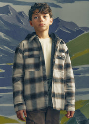 Boy wearing Mayoral Nukutavake hooded check flannel shacket over white tee – on model front view