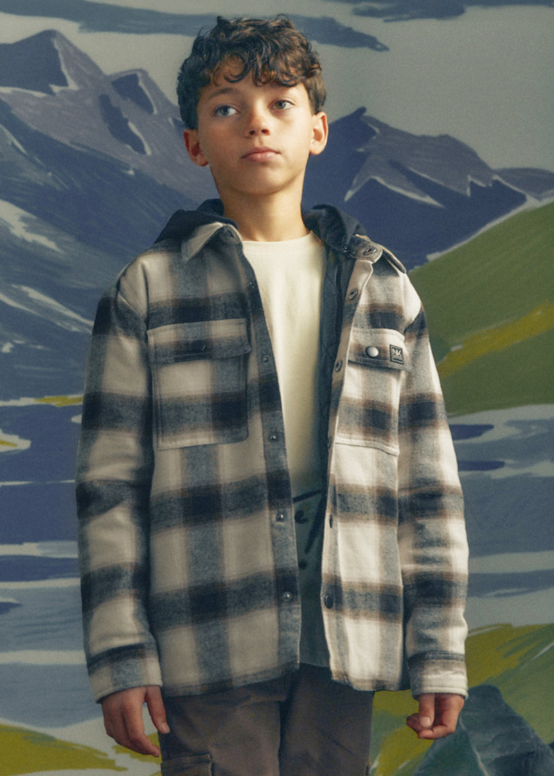 Boy wearing Mayoral Nukutavake hooded check flannel shacket over white tee – on model front view