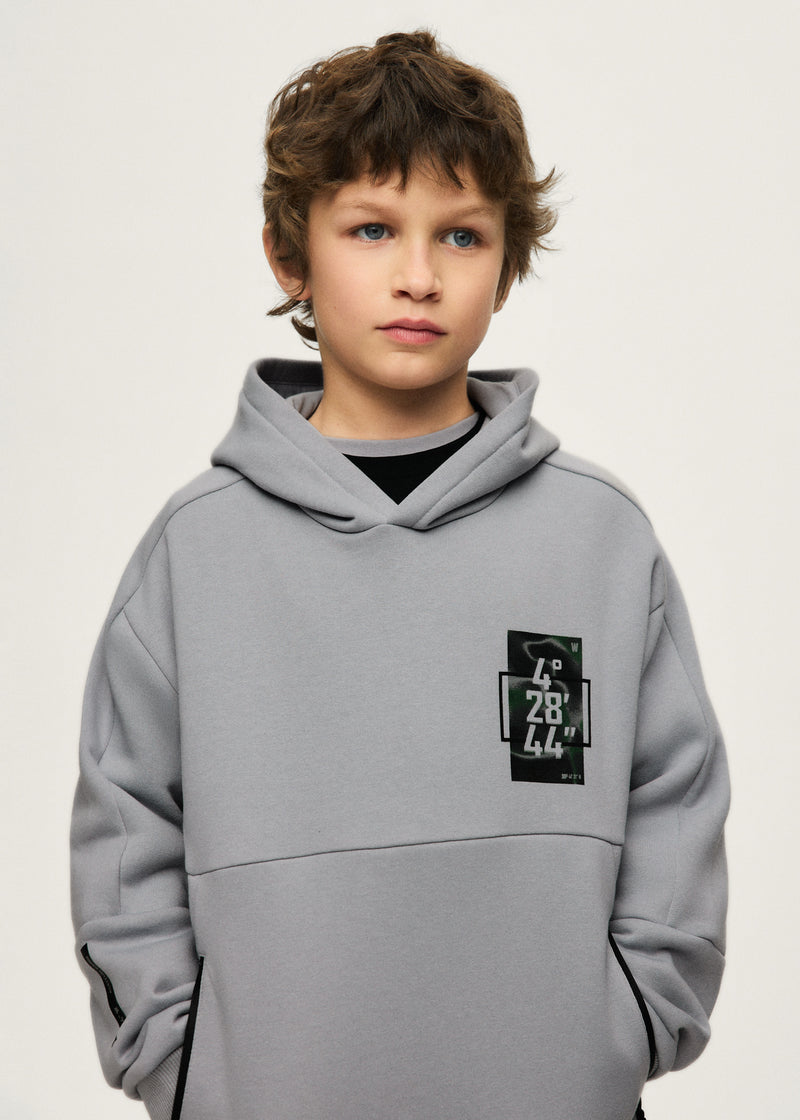 Boy wearing Mayoral Nukutavake tech hoodie – close-up showing coordinates chest patch and zip pocket detail