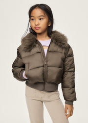Girl wearing Mayoral khaki cropped puffer jacket with faux fur collar – on model front view styled with cream jeans