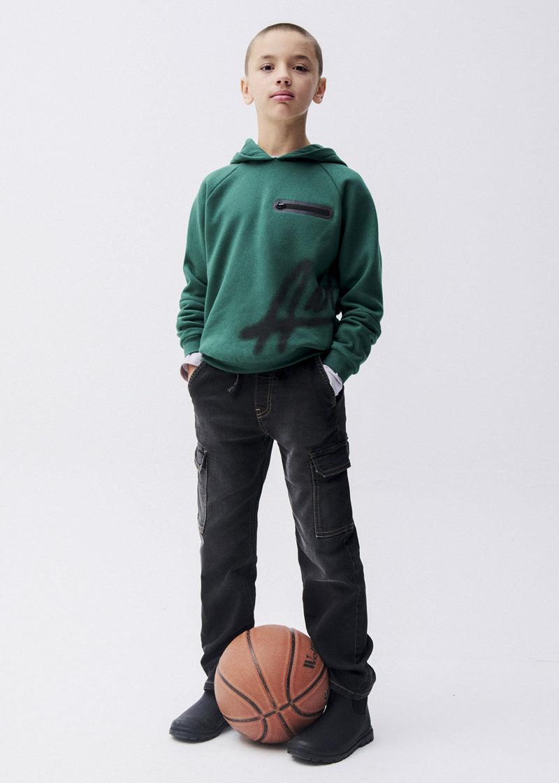 Boy wearing Mayoral Nukutavake black cargo trousers with forest green zip hoodie and basketball – on model full body front view