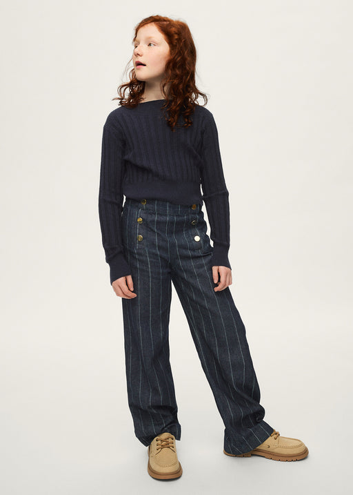 Girl wearing Mayoral navy pinstripe wide-leg trousers with navy ribbed knit top and tan boat shoes – on model full body view