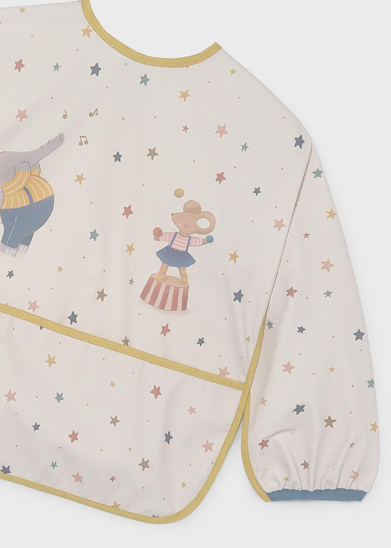 Mayoral baby circus star long-sleeve smock bib – front flat lay showing full star print, mustard piping, circus appliqué and front pocket