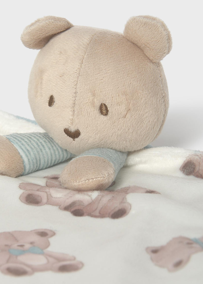 Mayoral baby teddy bear comforter – close-up of plush bear head showing embroidered eyes, nose and heart-shaped mouth with blue stripe ribbed arms and teddy print blanket detail